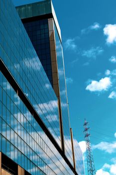 Genova, Italy-January 29, 2022: Beautiful modern high-rise buildings against the sky. 3d illustration on the theme of business success and technology. clouds reflection on the mirror.Industrial zone.