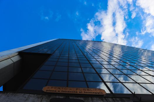 Genova, Italy-January 29, 2022: Beautiful modern high-rise buildings against the sky. 3d illustration on the theme of business success and technology. clouds reflection on the mirror.Industrial zone.