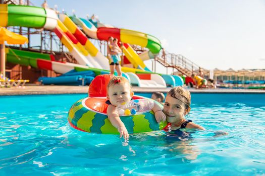 Baby swims in a circle in the pool. Selective focus. Nature.