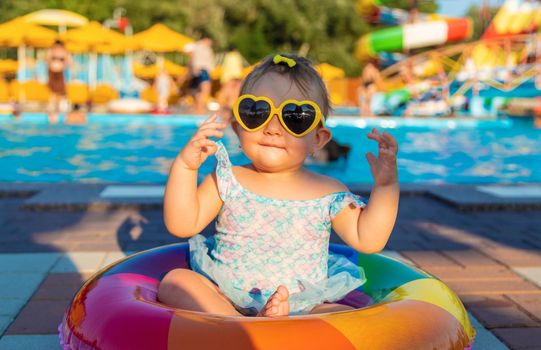 Baby with a circle near the pool. Selective focus. Child.