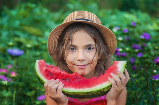 The child eats watermelon in the summer. Selective focus. Baby.