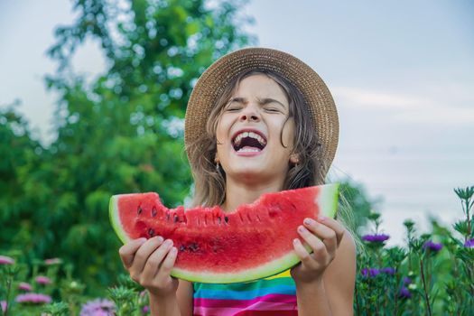 The child eats watermelon in the summer. Selective focus. Baby.