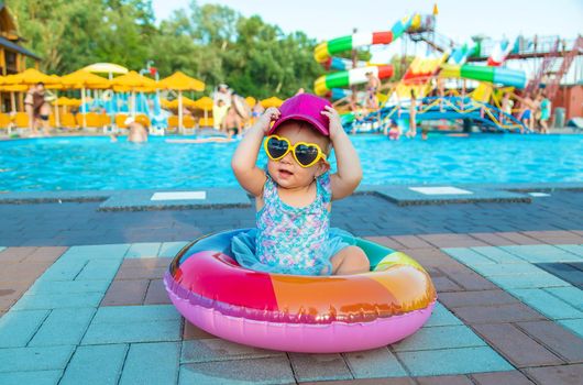 Baby with a circle near the pool. Selective focus. Child.