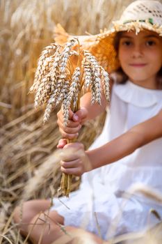 A child in a wheat field. Selective focus. Nature.