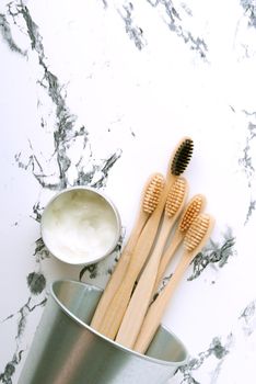 bamboo teeth brushes in bathroom on marbel background with copy space. High quality photo