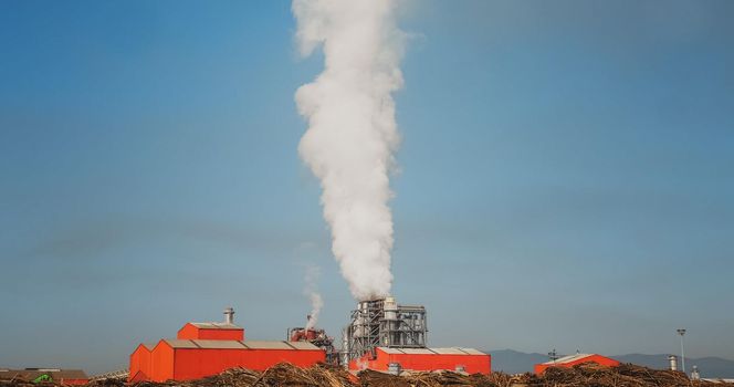 SMOKE Pollute Industry Atmosphere With Smoke Ecology pollution, Industrial Factory Pollutes. Global Warming. Smoke details on blue sky background.