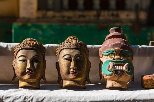 A stall selling Buddhist masks in front of an ancient temple in Myanmar