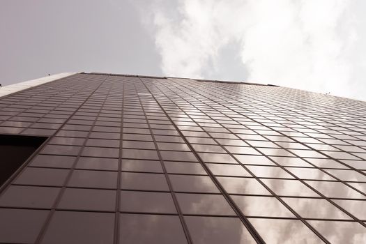 Genova, Italy-January 29, 2022: Beautiful modern high-rise buildings against the sky. 3d illustration on the theme of business success and technology. clouds reflection on the mirror.Industrial zone.