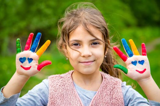 Smile on the hands of a child drawing. Selective focus. Kid.