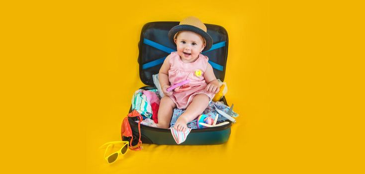 Baby and suitcase with things, luggage travel concept. Going on vacation at sea. Selective focus. Child.