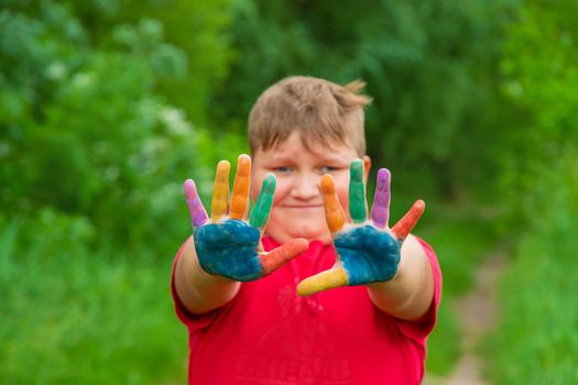 Smile on the hands of a child drawing. Selective focus. Kid.