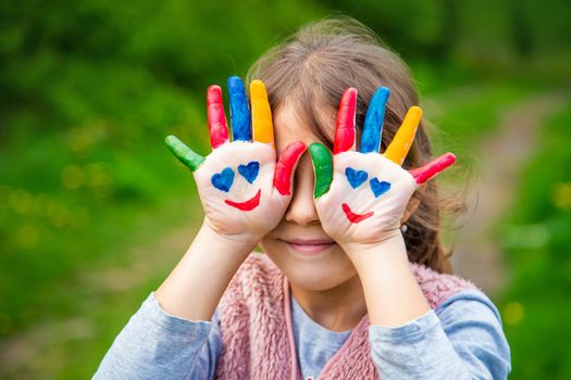 Smile on the hands of a child drawing. Selective focus. Kid.