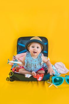 Baby and suitcase with things, luggage travel concept. Going on vacation at sea. Selective focus. Child.