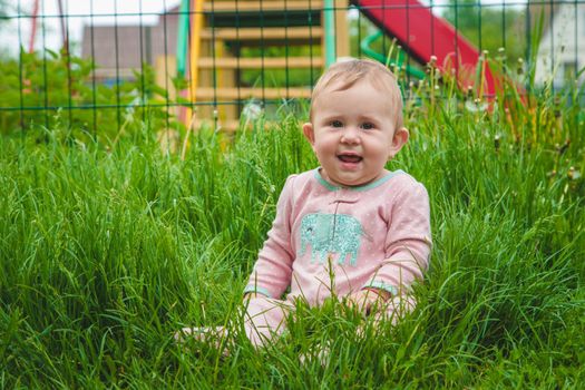 Baby is lying on the grass. Selective focus. Nature.