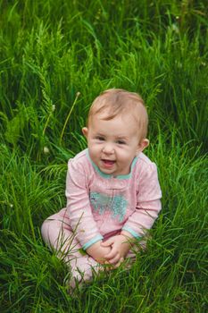 Baby is lying on the grass. Selective focus. Nature.