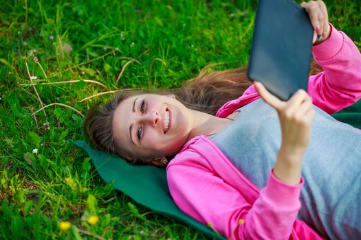 portrait of a girl with a tablet in nature