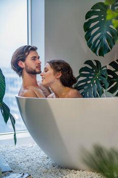 young couple bathing in the bathroom