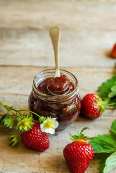 Homemade strawberry jam in a jar. Selective focus. Food.