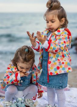 children eat chocolate covered cake with their hands