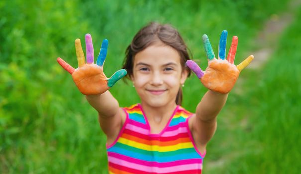 Smile on the hands of a child drawing. Selective focus. Kid.