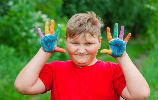 Smile on the hands of a child drawing. Selective focus. Kid.