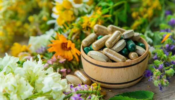 Supplements and vitamins with medicinal herbs. Selective focus. Nature.