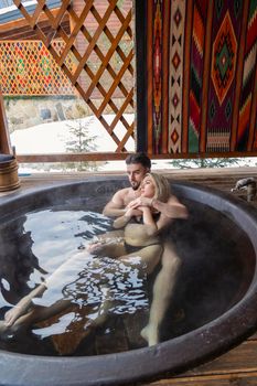 young, beautiful couple bathes in a vat