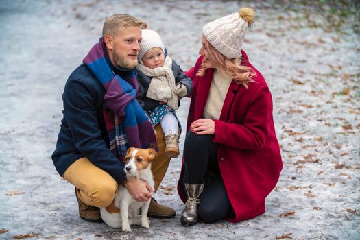 family with dog in winter park