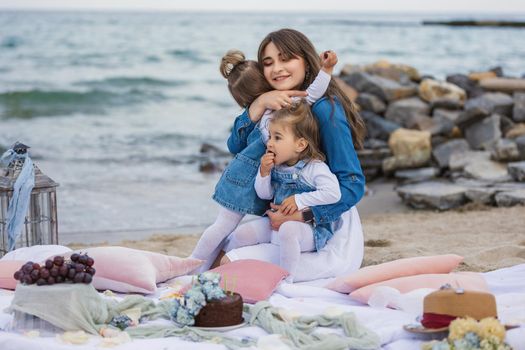 mother with children relaxing on the beach