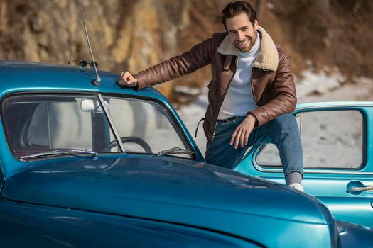 handsome man driving a retro car