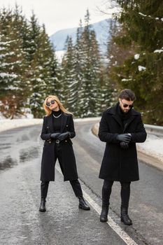 couple walking along the car road in the woods