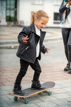 child and mom ride a skateboard