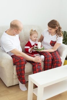 Child girl dressed in christmas dress with cochlear implants having fun at home - hearing aid and innovating technologies for treatment deafness