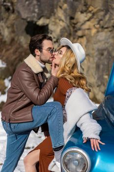 stylish couple hugging near retro car