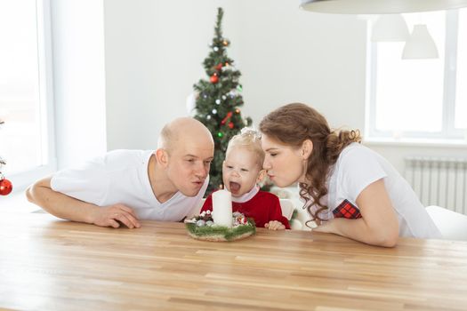 Baby child with hearing aid and cochlear implant having fun with parents in christmas room. Deaf and health