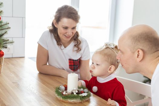 Baby child with hearing aid and cochlear implant having fun with parents in christmas room. Deaf and health