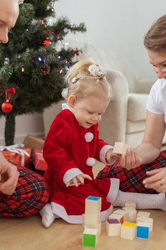 Toddler child with cochlear implant decorating christmas tree deafness and innovating medical technologies for hearing aid