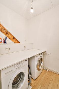 White wardrobe with washing machine in light room at home