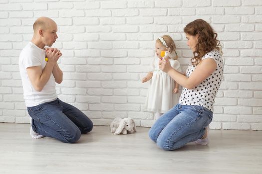 Mother holds her child with hearing aids and cochlear implants . Deaf and health