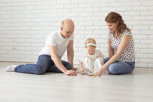 Mother holds her child with hearing aids and cochlear implants . Deaf and health