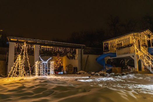 courtyard decorated with glowing garlands, prepared for the New Year holidays
