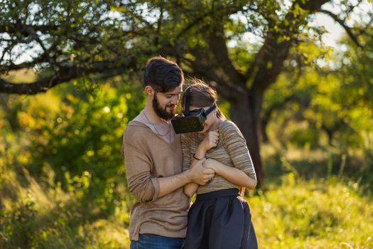 couple in nature, girl in virtual reality glasses close-up