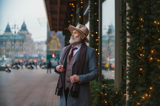 portrait of a bearded man aged on the street in the city