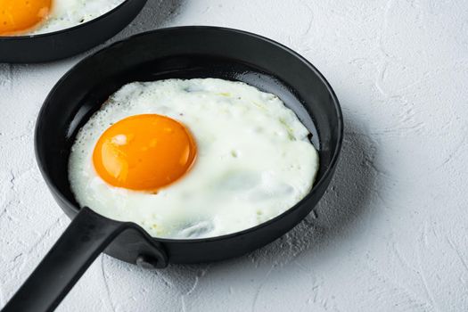 Fried Egg with ingredient in cast iron frying pan, on white background