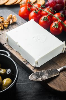 Traditional greek feta cheese set, on black wooden table