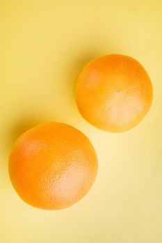 Fresh grapefruits set, on yellow textured summer background, top view flat lay, with copy space for text