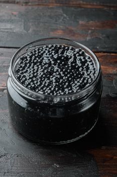 Black Caviar jar, on old dark wooden table background