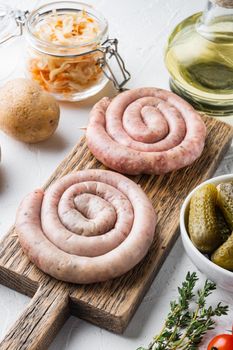 Fried Bavarian German Nürnberger sausages with sauerkraut, mashed potatoe, on white background