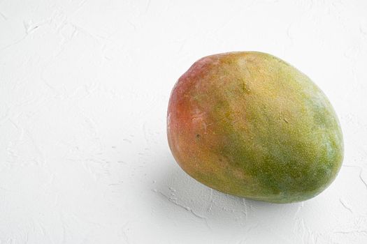 Large whole tasty Mango set, on white stone table background, with copy space for text
