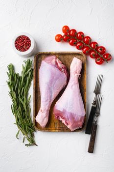 Fresh turkey legs with ingredients for cooking set, on white stone table background, top view flat lay